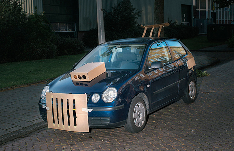 Illustration for article titled This Artist Turns Boring Rides Into Supercars At Night Using Cardboard
